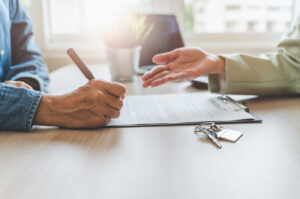 A tenant signing a rental agreement.