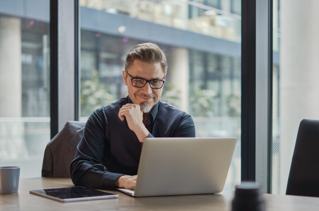 A man working on a laptop.