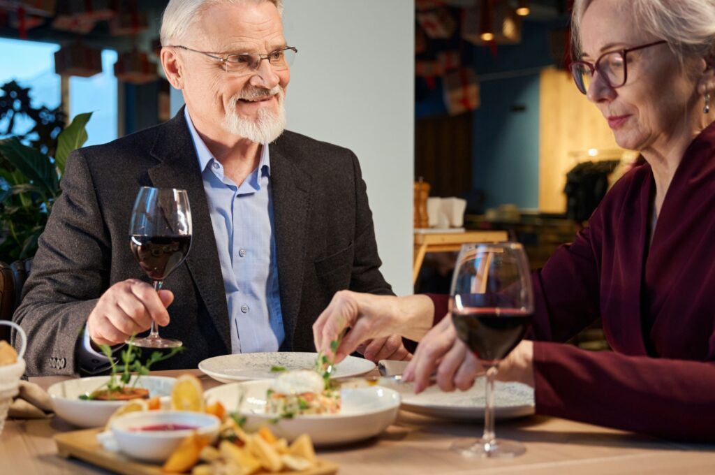 A couple enjoying a meal in a restaurant together.