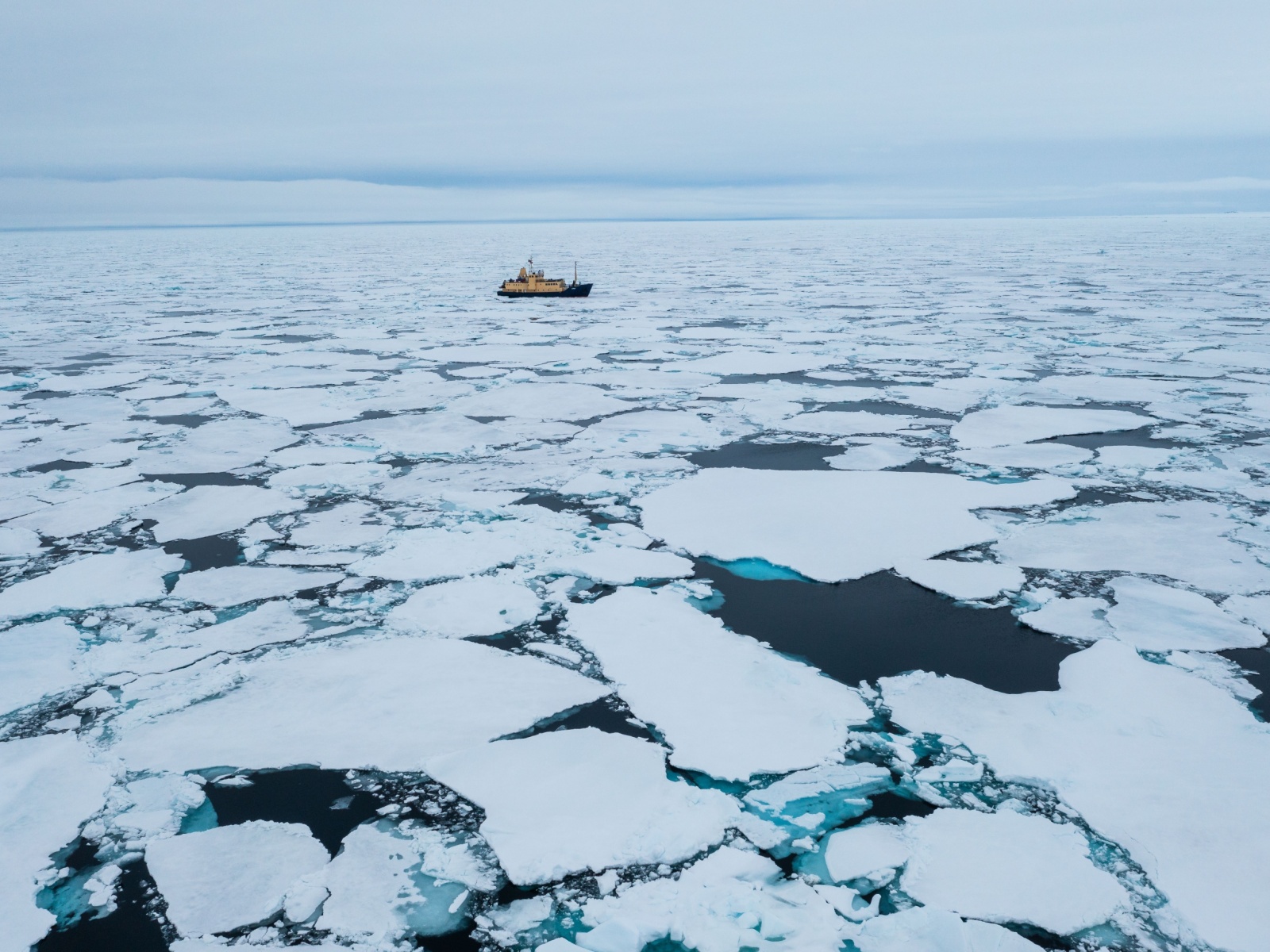 A ship cruising through sea ice.